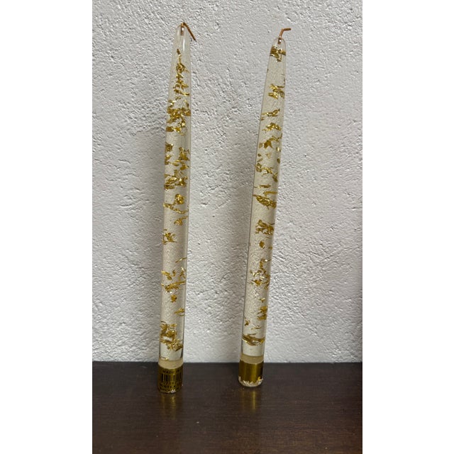Set of 7 faux tapered candle sticks made out of clear plastic with floating gold flecks. Each candle stick has its...