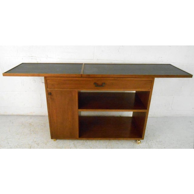 This unique midcentury bar cart features a unique sliding slate style top that expands to 62 inches wide to reveal locking...