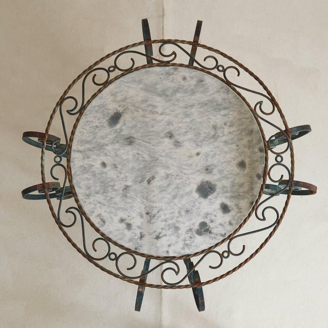 Dating to the 1960s, this French table in hand-forged iron is a study in movement and ornament. The base is composed of...