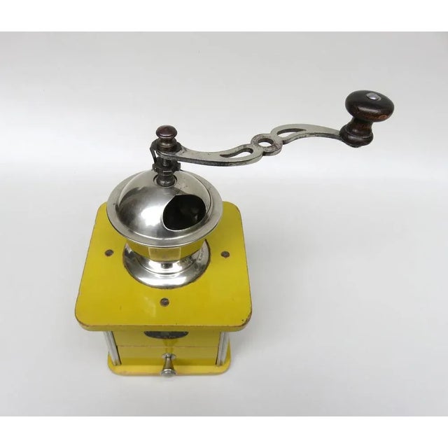 This coffee grinder in the original color ocher is the anniversary grinder for the 100th anniversary of the company k & m...