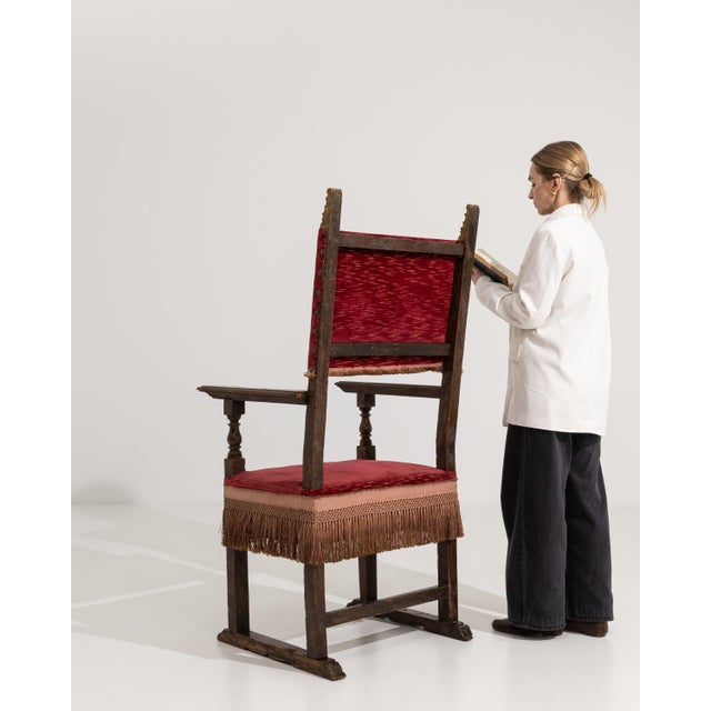 An 18th century French throne chair in the Renaissance style, constructed in wood with upholstered elements. The design...