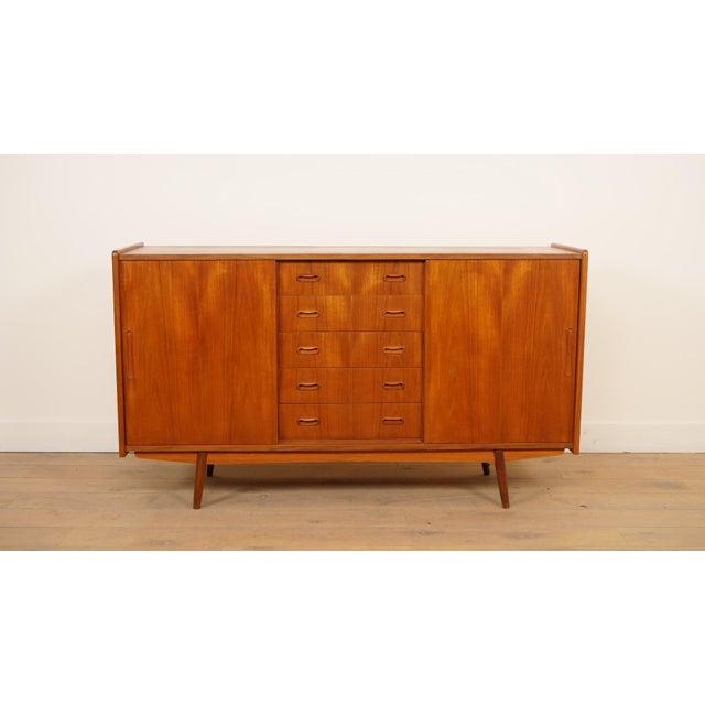 Beautiful Scandinavian vintage sideboard from the 1960s with a warm wood color and a refined, timeless design. The piece...