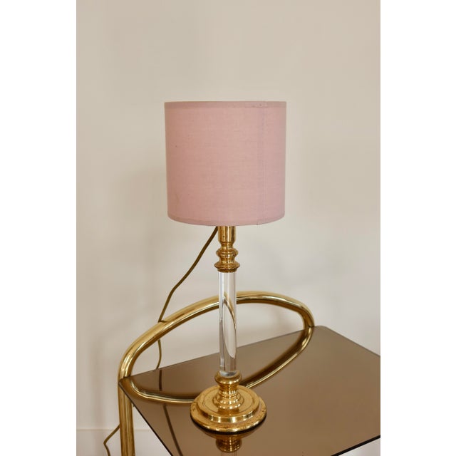Pair of elegant vintage bedside lamps, combining a gold-tone metal base with a clear acrylic stem in an Art Deco-inspired...