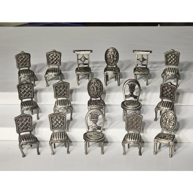Add an elegant and whimsical touch to your table with this delightful set of 16 vintage pewter place card holders, each...