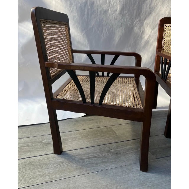Great pair of Deco-period British colonial hand-caned teakwood club chairs. Recently restored and recaned. Ready for...