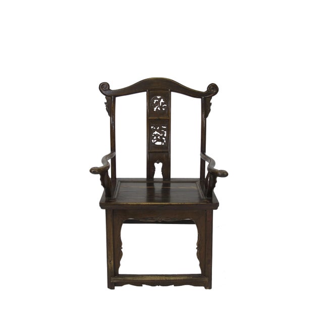 This early 20th century high yoke back armchair has 2 carved circle on the back splat and dramatic protruding crest rail....