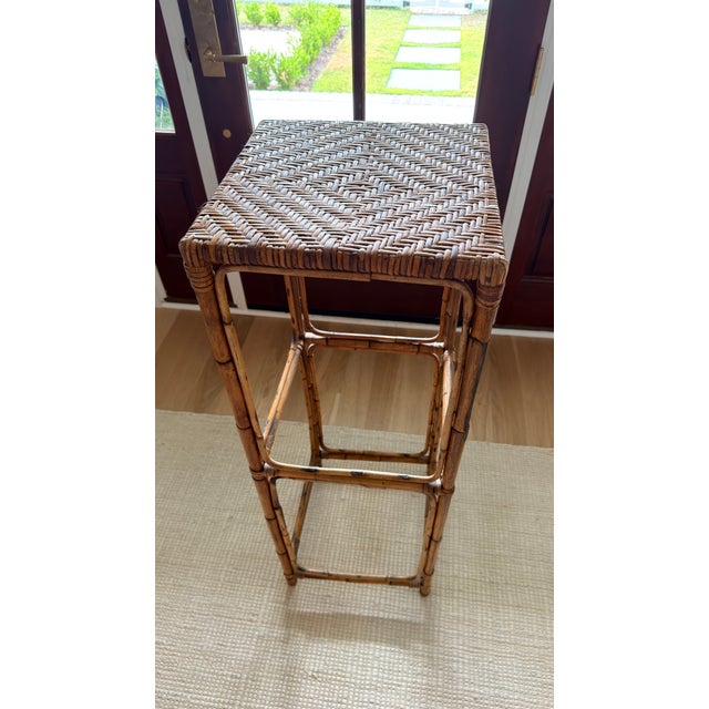 A beautifully crafted vintage plant stand in tortoiseshell bamboo with a tightly woven herringbone rattan top. Slender,...