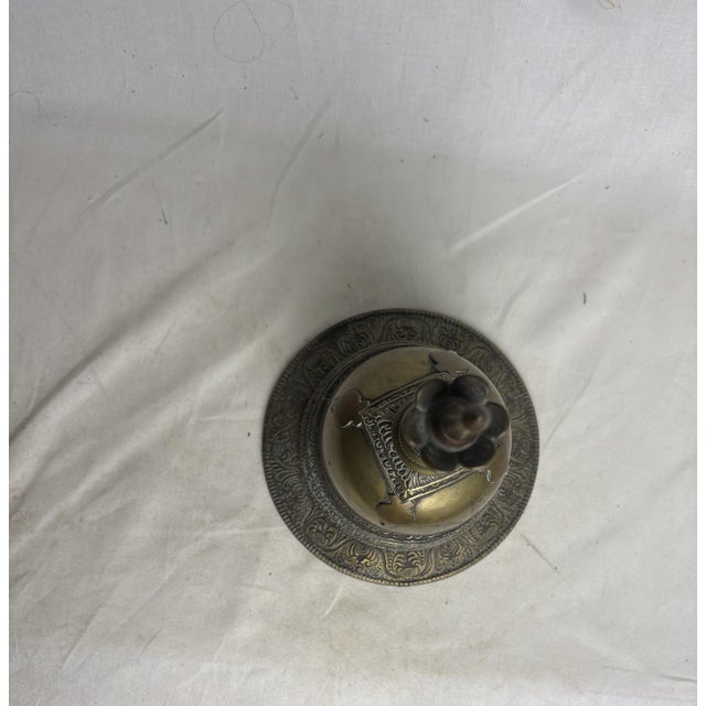 A very solid piece, about 3.5 pounds! Most likely Burmese due to the shape, size, and design, although we can't say with...