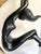 Here is a dramatic vintage Art Deco sculpture featuring a graceful female figure suspended within a polished brass...
