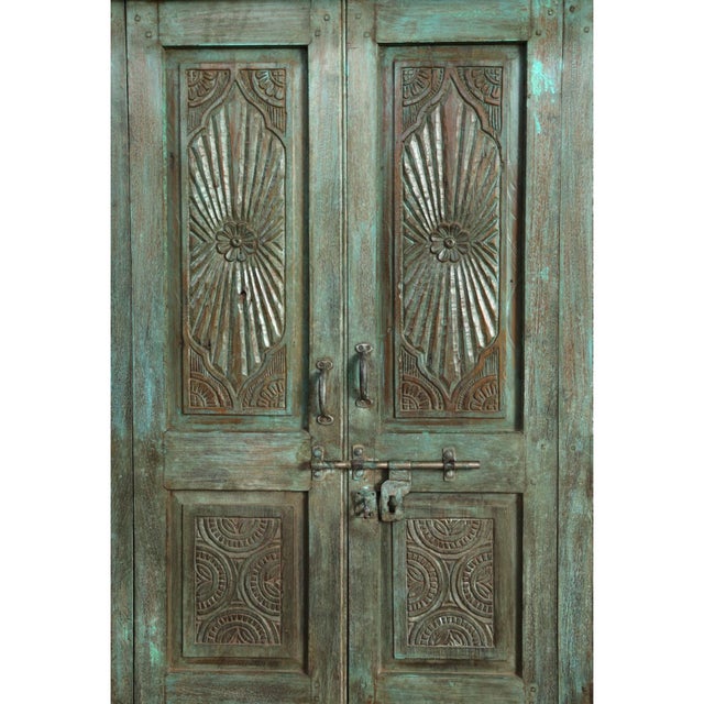 Antique Carved Indian Teak Double Hinged Doors, beautifully restored to preserve their unique sunwashed charm. Featuring a...