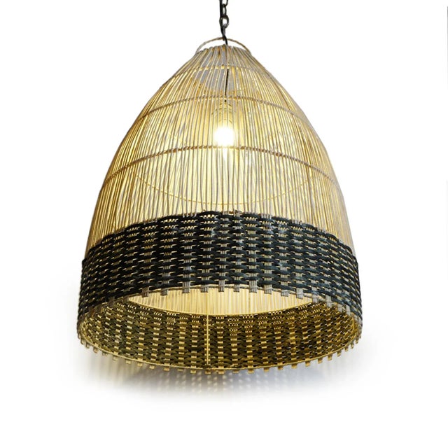 Sculptural hand woven pendant light showcasing the natural beauty of finely crafted wicker in a softly tapered,...