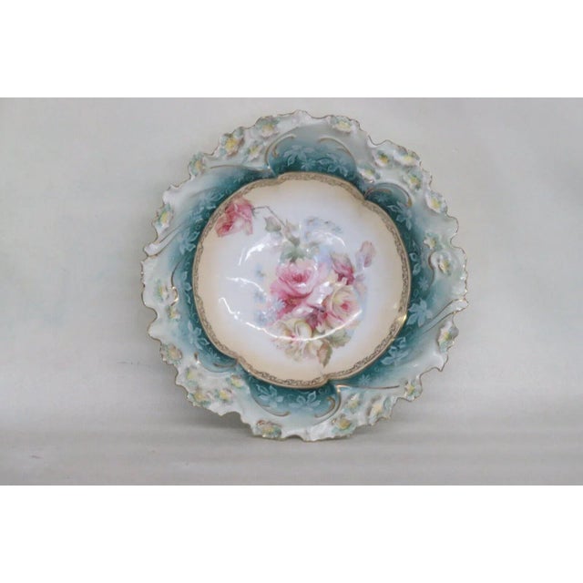 This gorgeous large bowl is made of porcelain. This piece has a gorgeous motif of pink and yellow roses decorating the...