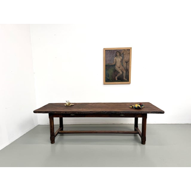Large 1920s solid oak farmhouse table with two drawers in the apron. It's a classic French country table, but with a more...
