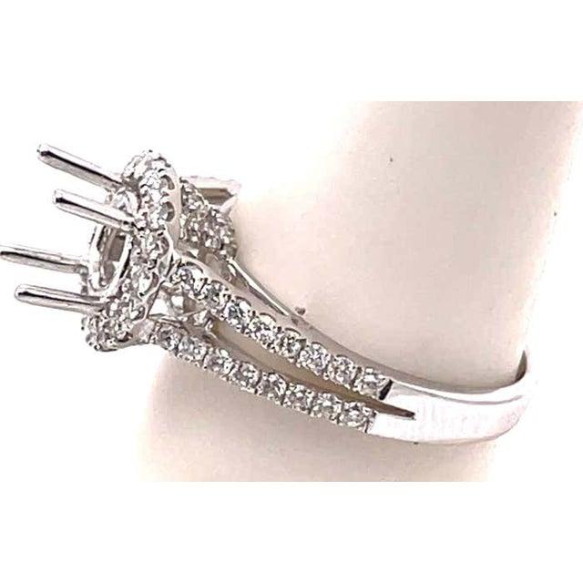 18 Karat White Gold round engagement ring setting with diamond halo and two-row diamond band. Size 6.5 0.71 total diamond...