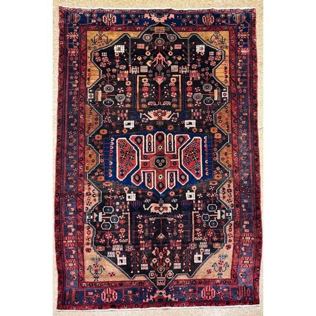 Antique hand-knotted rug from the Nahavand region of western Iran, featuring a complex geometric-medallion composition set...