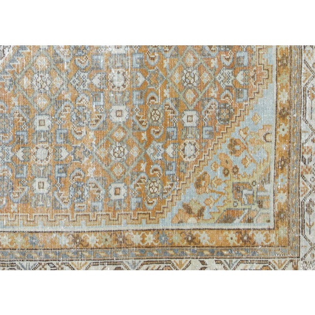 This semi-antique Persian Melayer rug, sized 5' x 6'9", is handwoven in Iran’s Hamadan region and thoughtfully distressed...