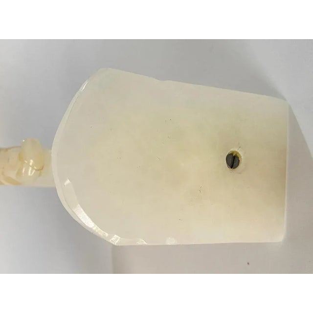 Pair of bookends, in onyx, the motif pattern are horse heads. They are white in color, and were made in France in the 1970s.