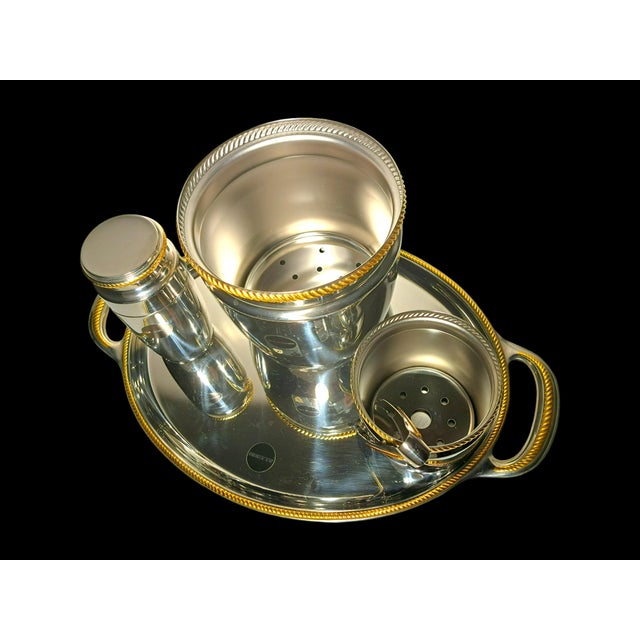 Alessi barware set, 1970s, for serving drinks in style, Mercurio model. Each piece is embellished with a gold cord-shaped...