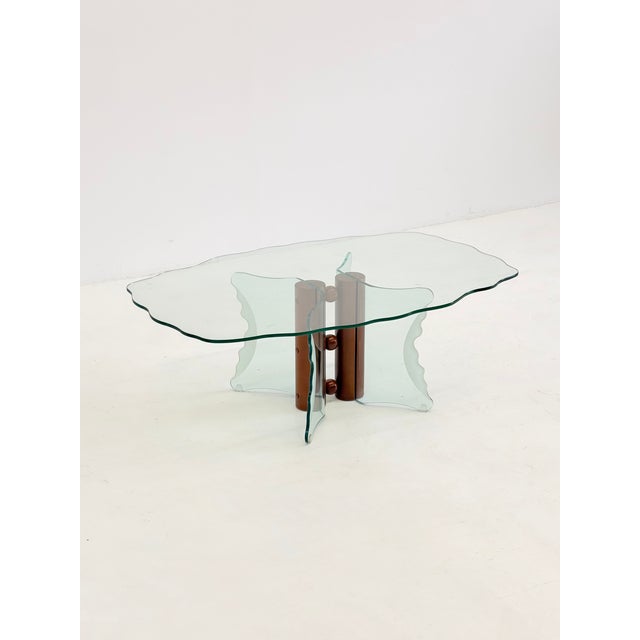 This striking vintage coffee table is a remarkable example of postmodern design from the 1980s . The design plays...