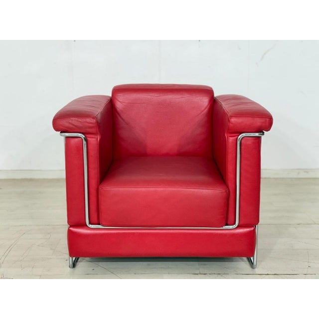 The Carat armchair by Züco is upholstered in black leather and stands on slender metal legs. The individual upholstered...