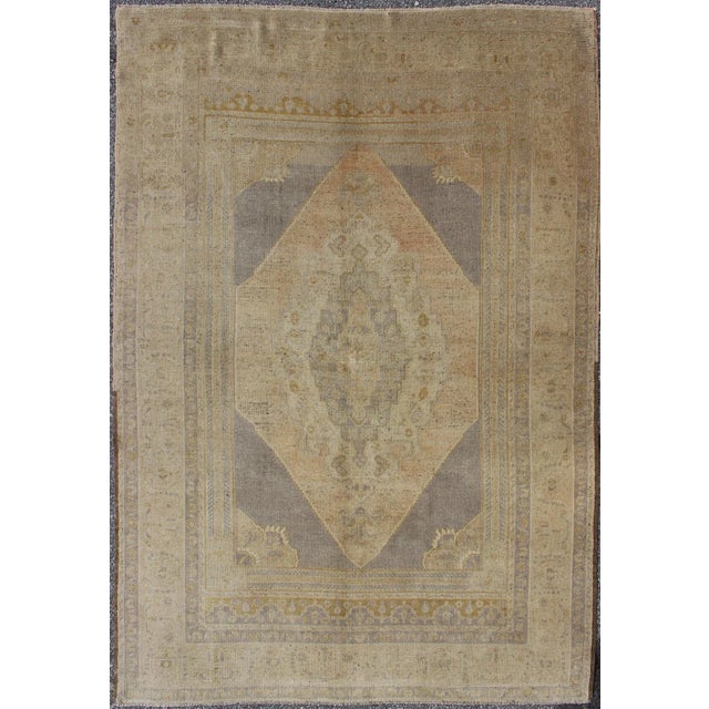Measures: 5'1 x 7'7. Vintage Turkish Oushak Rug with Faded Peach and Gray Medallion On Soft Taupe. Keivan Woven Arts / rug...