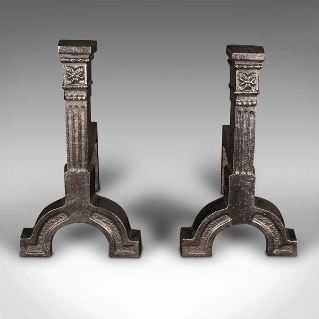 This is a large pair of antique andirons. An English, cast iron fire dog, dating to the late Victorian period, circa 1900....