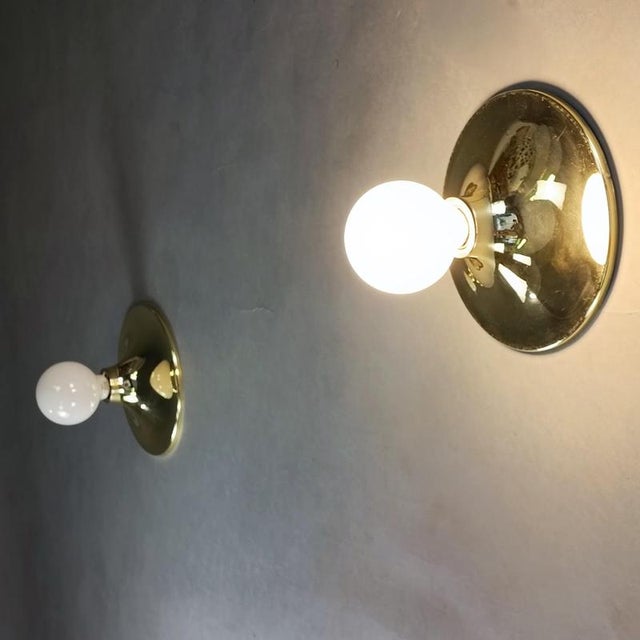Set of two gold wall lamps with a 1960s design. Gold-plated aluminum frame. They use a large E27 bulb. Fully functional...
