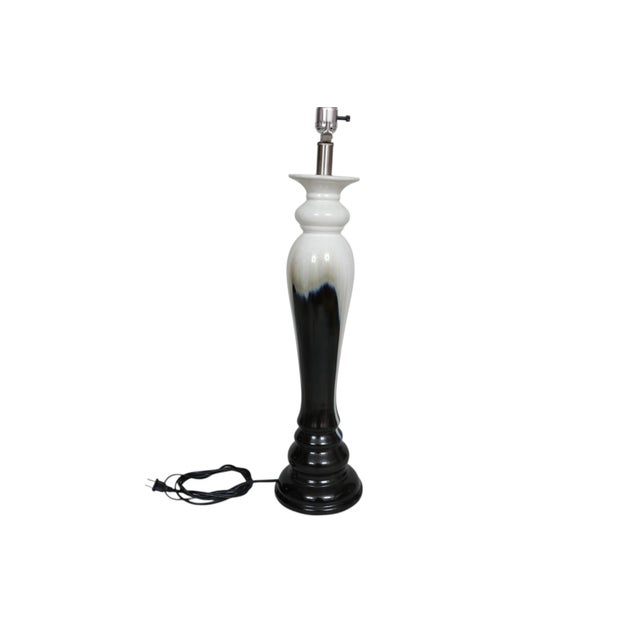 A Post Moderne period drip glaze ceramic table lamp. The tall baluster vase is elegantly turned and glazed with a black...