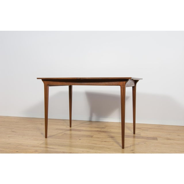 The rectangular table produced in the 1960s in Scotland by A.H. McIntosh. It is made from teak. The furniture has profiled...