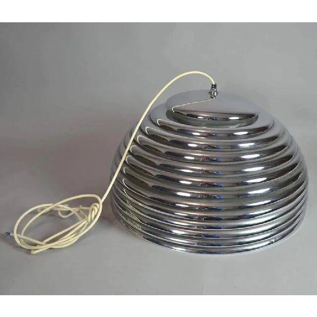 This chromed steel pendant model Saturno was designed in 1972 by Kazuo Montozawa for Staff Leuchten. It is fitted with...