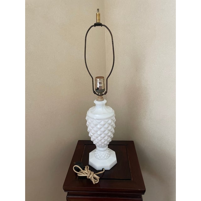 This milk glass lamp is beautifully proportioned with a pineapple shape. There is a “cutout” at base for wire placement....