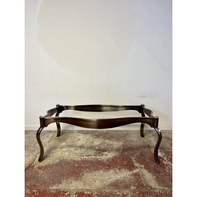 Wonderful post modern glass top coffee table. Smokey polished steel base with brass accent. Nice wavy lines in both base...