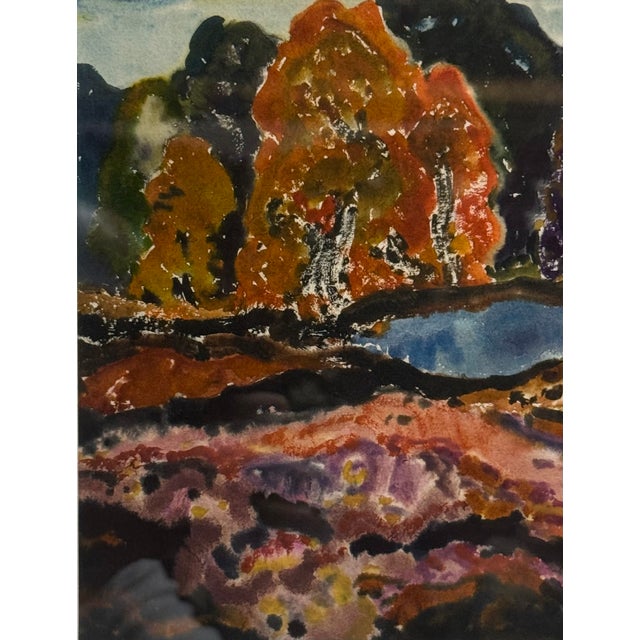 In the Manner of Thomas Moran (American 1837-1926). A landscape painting depicting an autumn scene with trees and water....