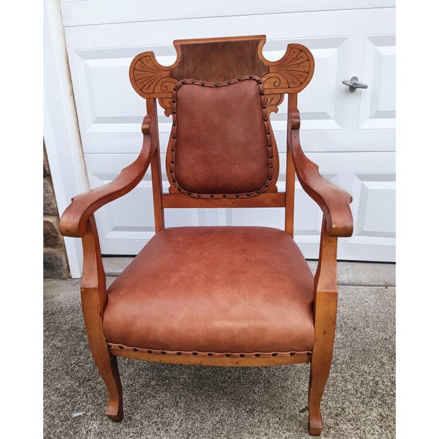 Rare Antique Victorian Carved Oak & Leather Throne Armchair with Matching Ottoman Bring a commanding piece of history into...