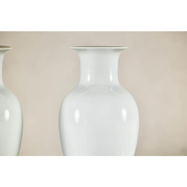 A pair of Chinese porcelain vases, these elegant pieces showcase a timeless silhouette and a lustrous white glaze that...