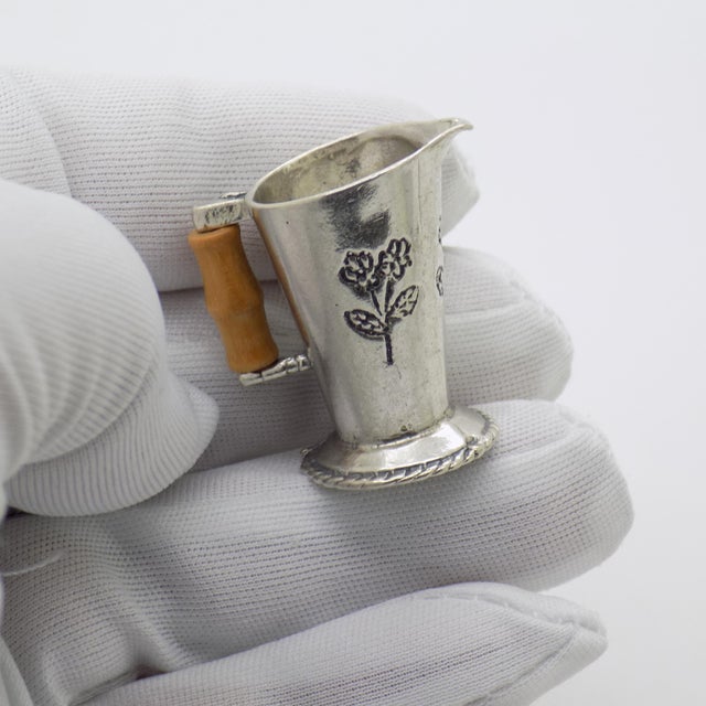 A rare and finely detailed miniature, this vintage Italian pitcher captures the elegance of traditional household...