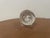 Elegant crystal art glass paperweight with a polished sculptural form. The piece appears to be signed on the base,...