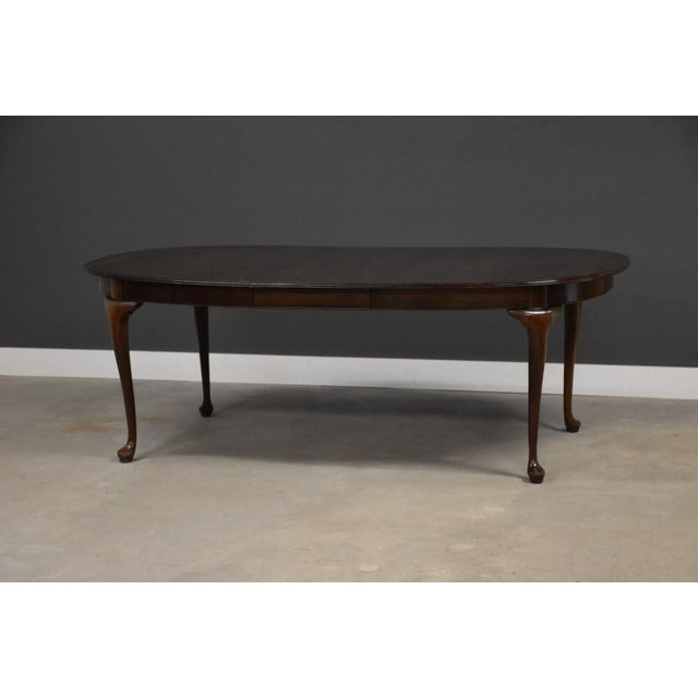 A solid cherry traditional Queen Ann style dining table with two 17.75 leaves made by Ethan Allen. Fully extends to...