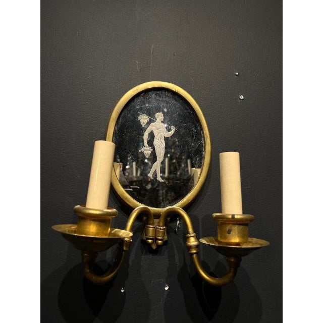 A pair of circa 1920’s Caldwell neoclassic style sconces with edged mirror backplate. Available 2 pair| price per pair