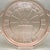 • This striking 1930s pink Depression glass cake plate showcases the classic "Doric" pattern manufactured by the Jeannette...