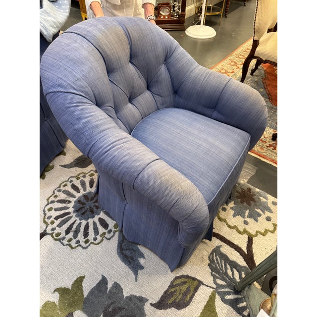 This is a club chair. It also is able to swivel. It is made by Kravet furniture. It has a woven linen fabric in a blue...