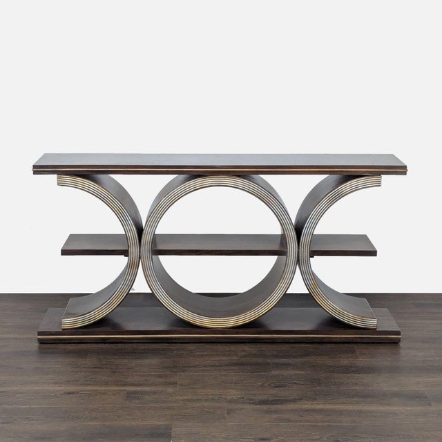 The table has a gold powder finish over a geometric silhouette and is crafted of walnut veneers. It has one shelf. Brand...
