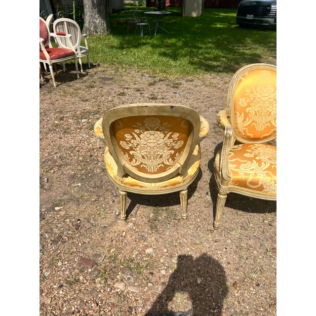 Elegant pair of 19th-century French Louis XVI armchairs, crafted from carved and painted walnut with fluted legs and...