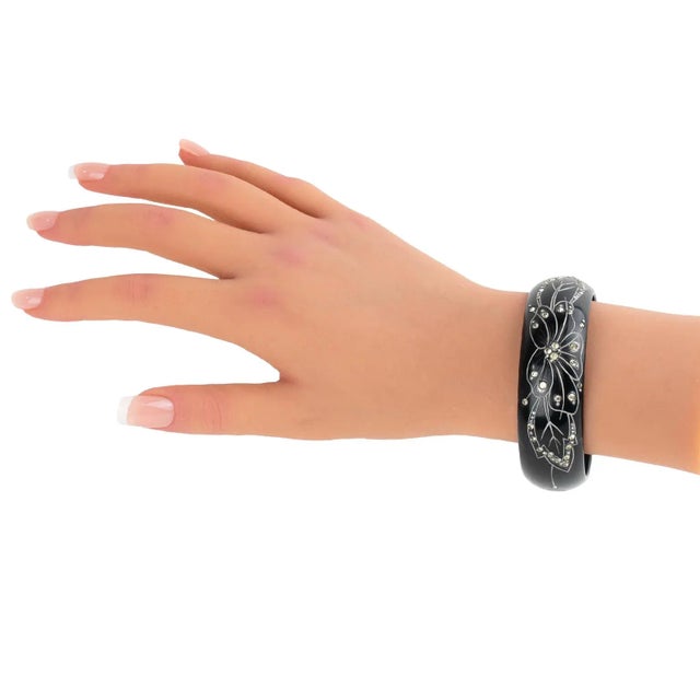 This stunning French Art Deco Galalith (or French Bakelite) bracelet bangle features an impressive floral carved design,...