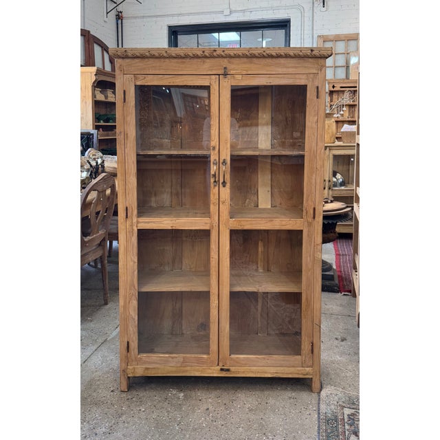 Beautifully crafted vintage wood cabinet featuring full-height glass-paneled doors and rich natural patina. Constructed...