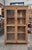 Beautifully crafted vintage wood cabinet featuring full-height glass-paneled doors and rich natural patina. Constructed...