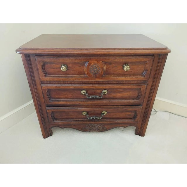 Elegant pair of Thomasville Country French three-drawer nightstands, beautifully crafted with the warm, timeless character...