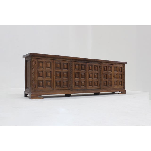 Spanish Brutalist Sideboard in solid wood from the 1960s. Beautifully designed with graphical squared wood carvings on the...
