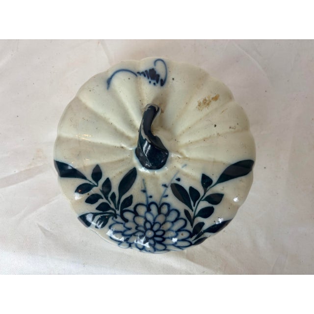 This gorgeous porcelain pot is shaped like a pumpkin/squash and has a blue on white floral design. The espresso colored...