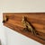 A Chinoiserie wall art composition composed of two antique Chinese giltwood pheasant carvings, salvaged from a larger bed...